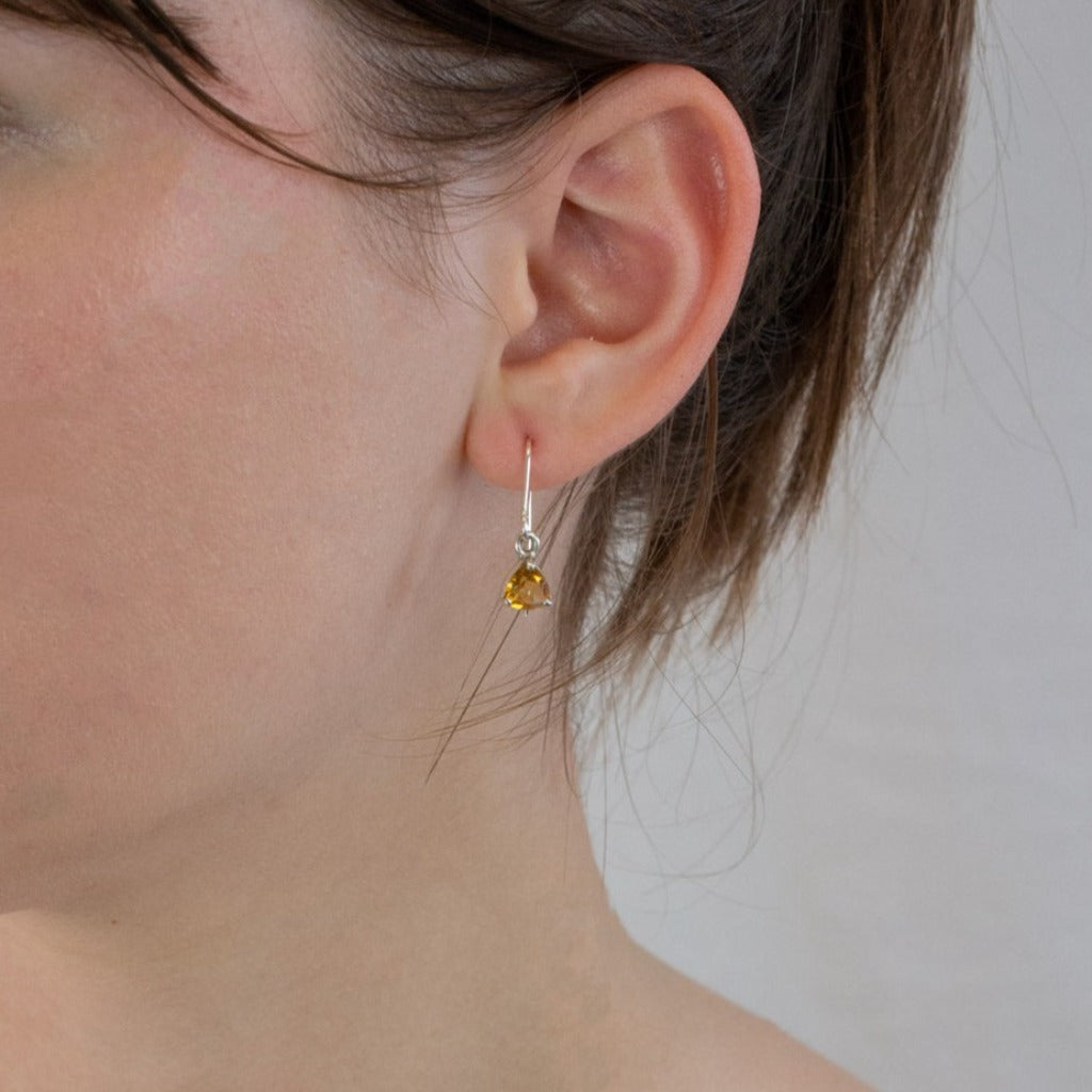 Faceted triangle Citrine drop earrings on model