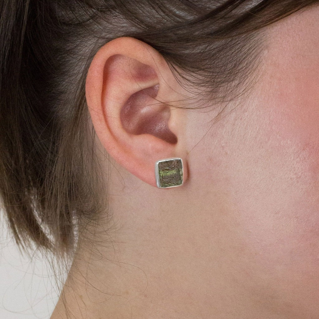Moldavite stud earrings on model