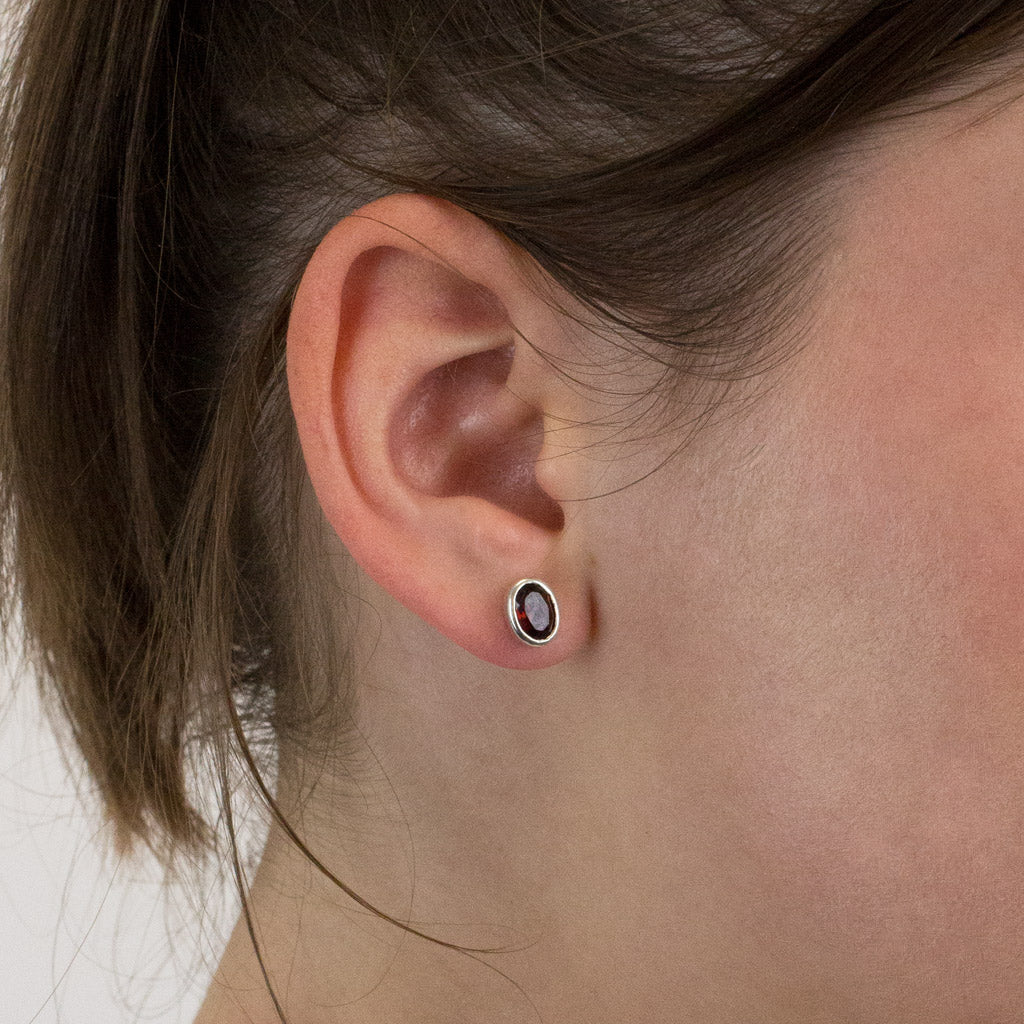 Garnet stud earrings on model