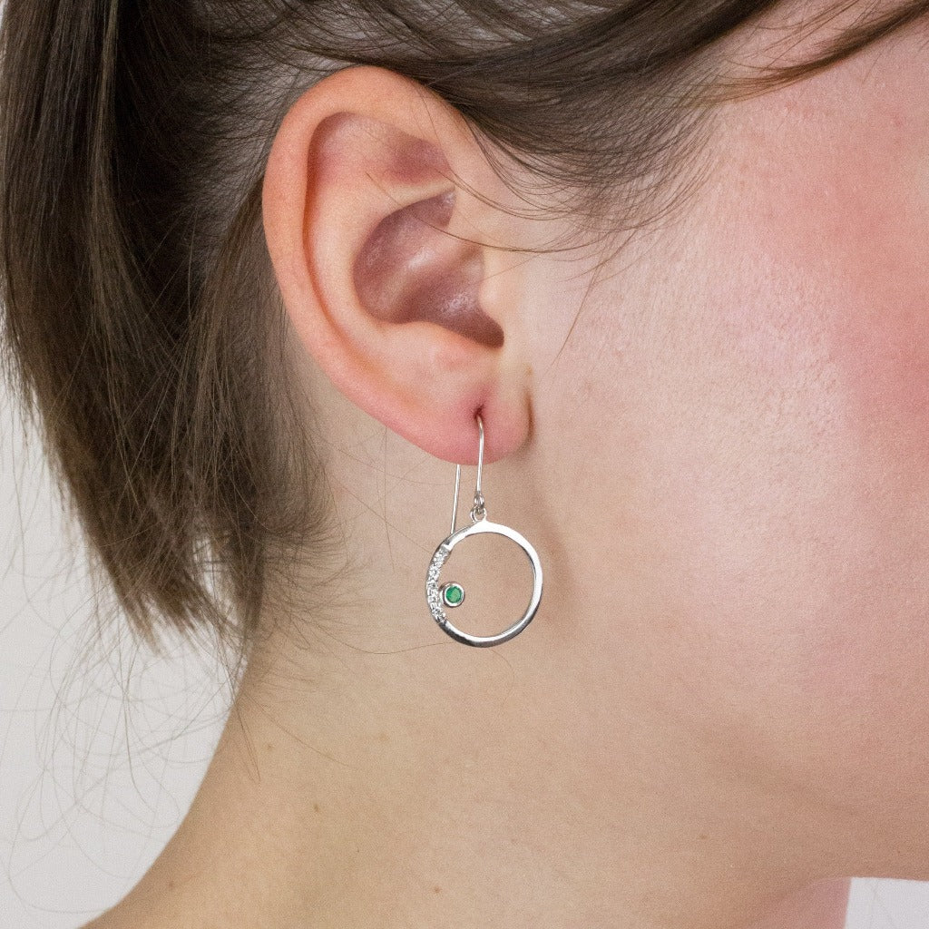 Emerald drop earrings on model