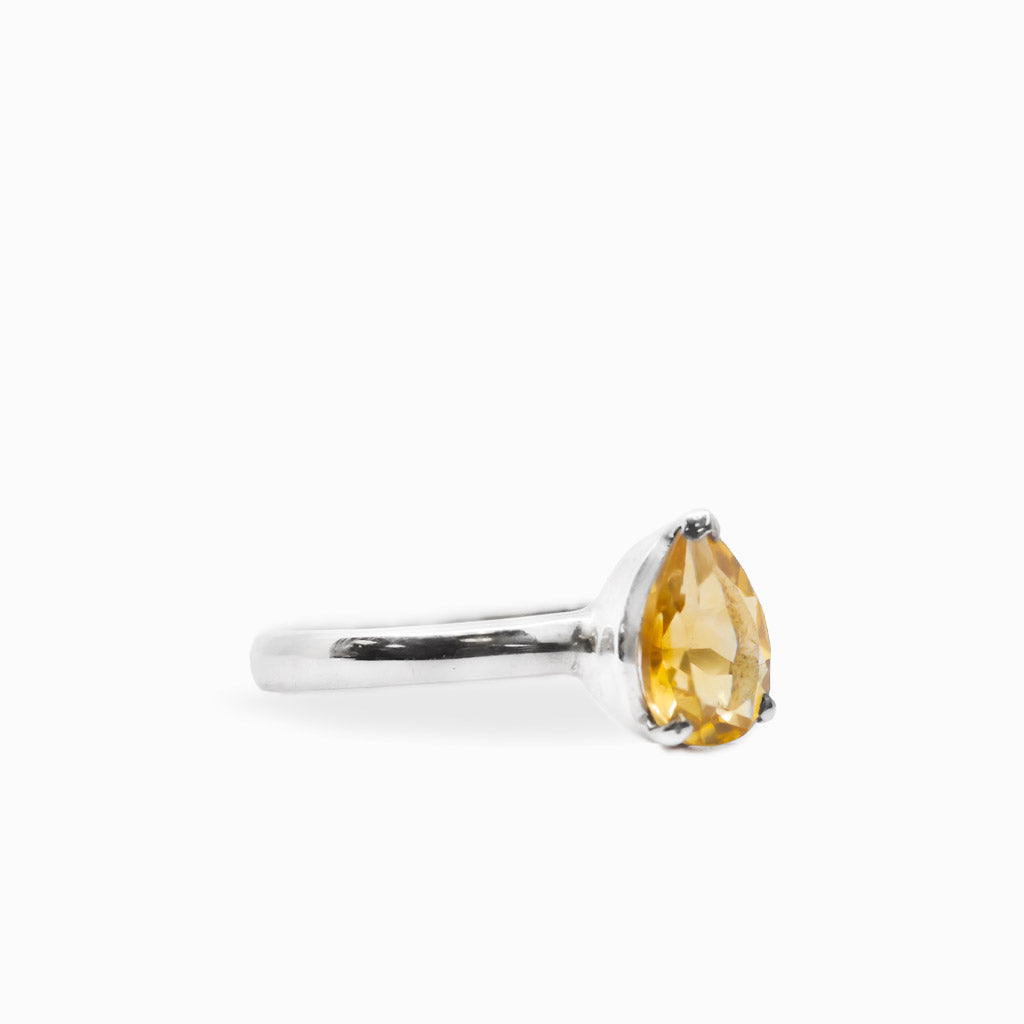Pear-shaped faceted golden Citrine ring in polished 925 sterling silver with a three-prong setting and slender silver band.