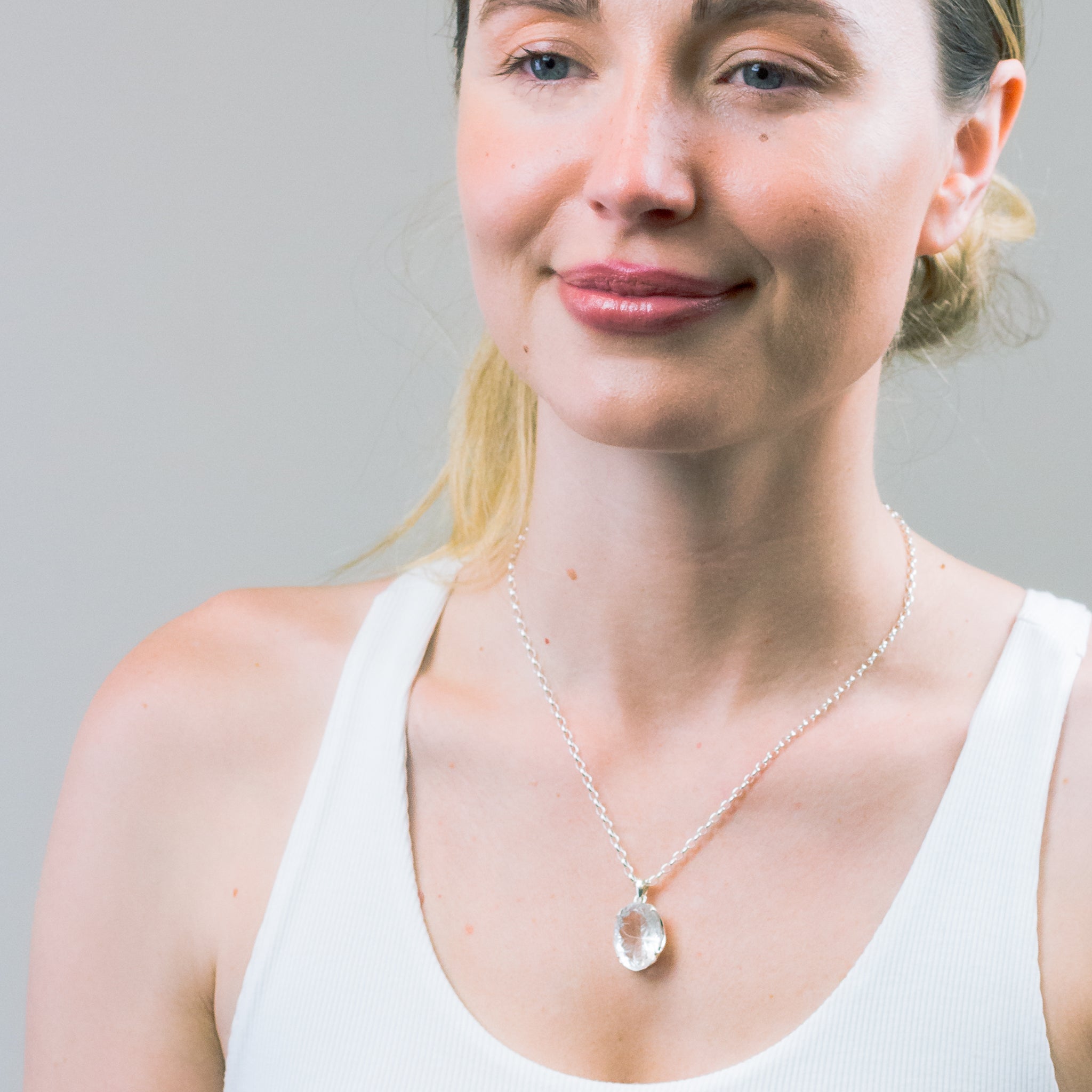 CARVED CLEAR QUARTZ NECKLACE ON MODEL