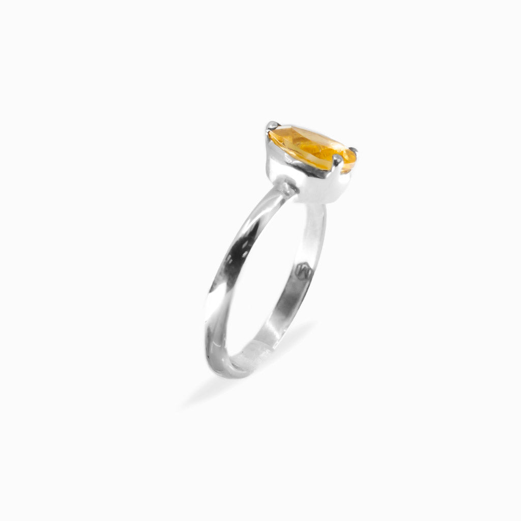 Pear-shaped faceted golden Citrine ring in polished 925 sterling silver with a three-prong setting and slender silver band.