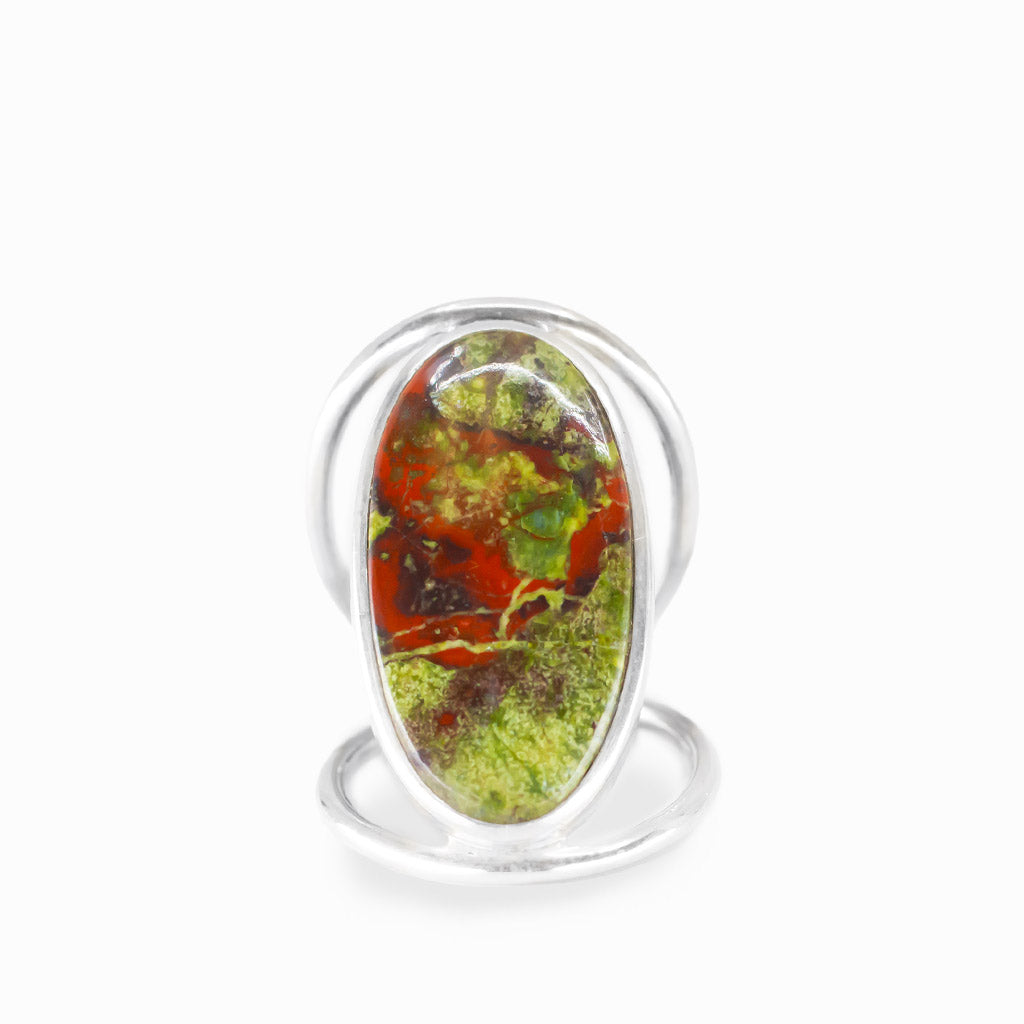 Oval Dragon's Blood Jasper ring with forest-green and crimson-red natural patterns, polished sterling silver bezel, and openwork band.