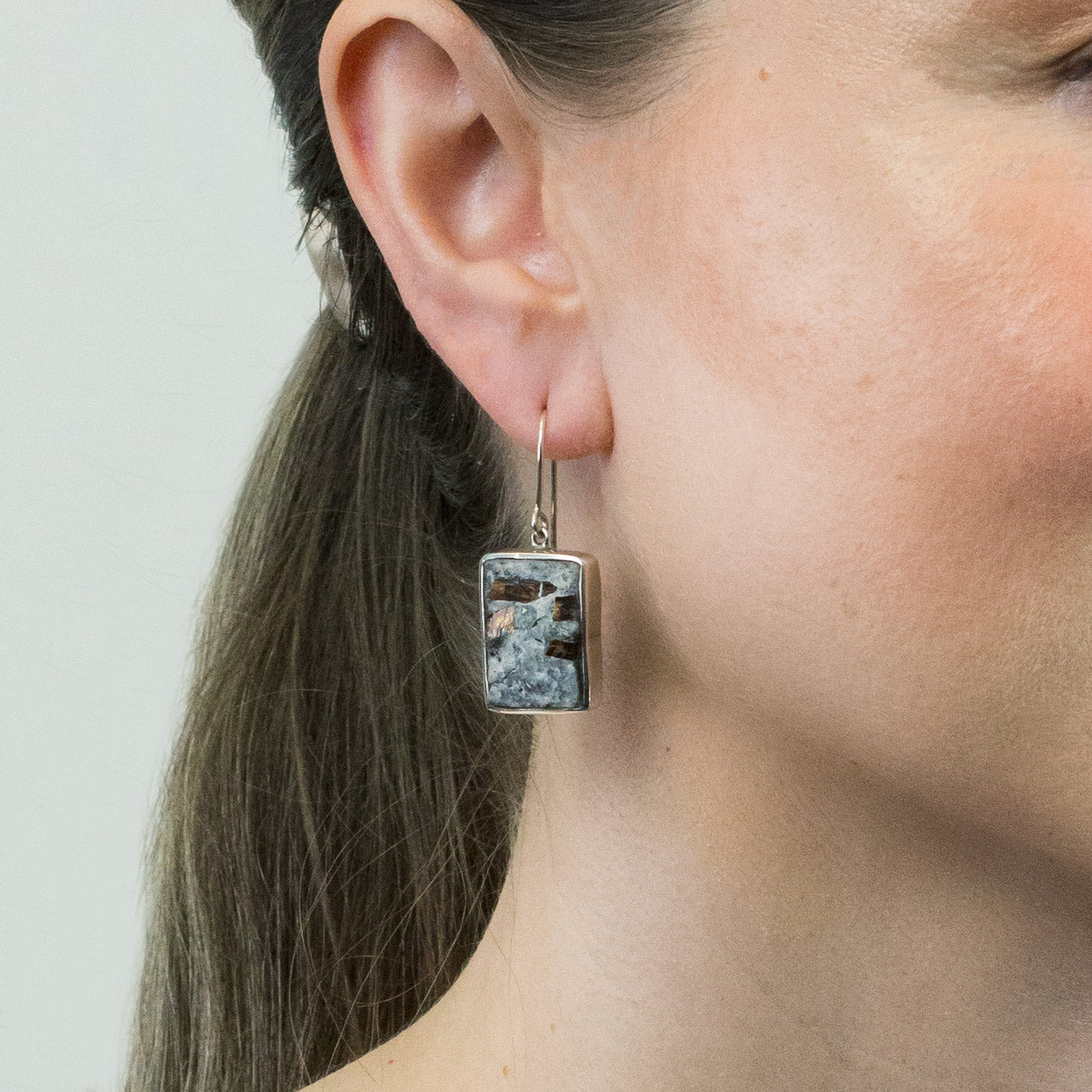 Astrophyllite drop earrings on model