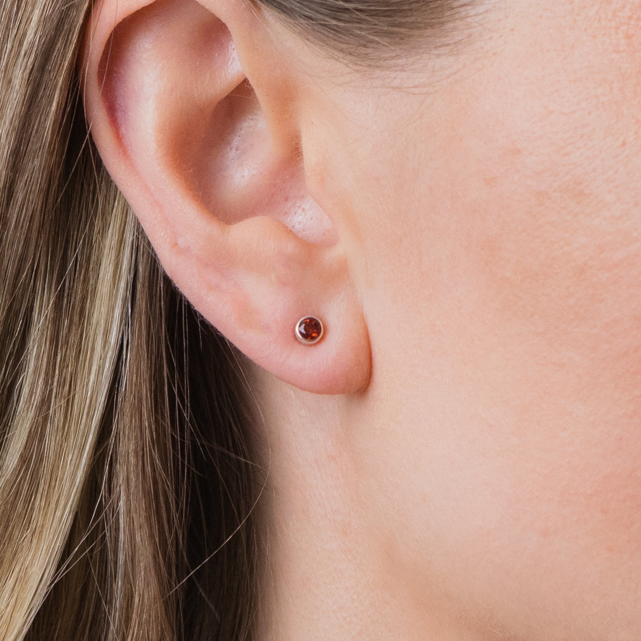 FACETED GARNET STUD EARRINGS ON MODEL