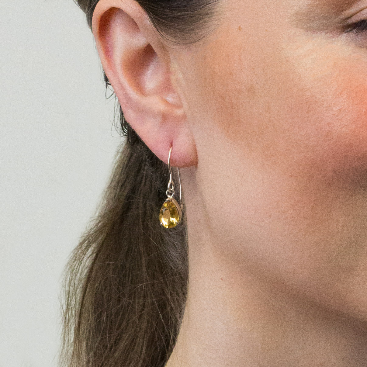 CITRINE DROP FACETED TEAR EARRINGS ON MODEL