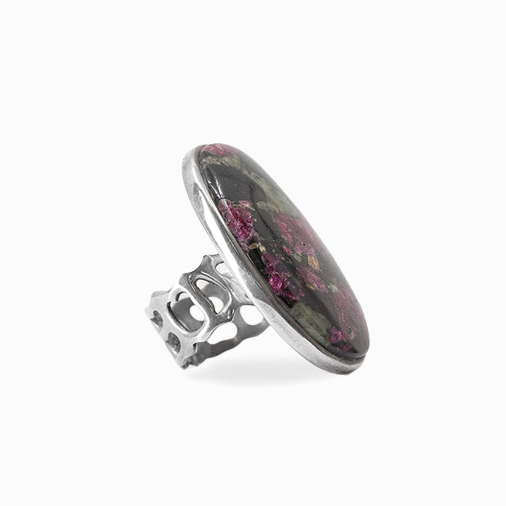 Oval Eudialyte cabochon with magenta, black and green natural patterning set in 925 sterling silver.