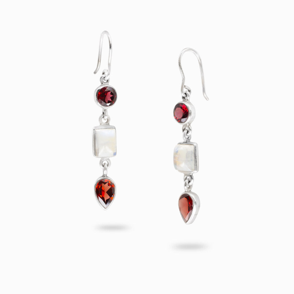 Sterling silver double drop earrings featuring faceted round Garnet, rectangular Rainbow Moonstone, and pear-shaped Garnet gemstones.