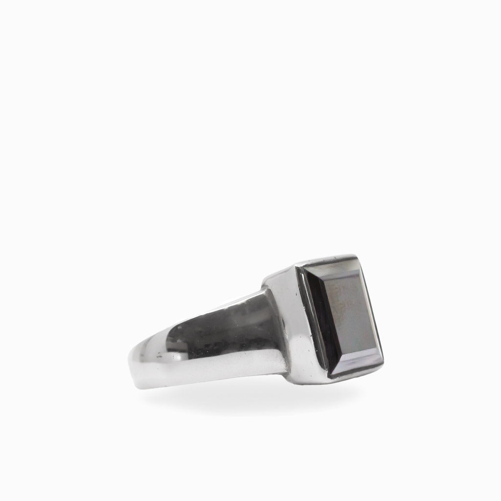 Dark metallic rectangular faceted Hematite gemstone set vertically in a polished 925 sterling silver ring.