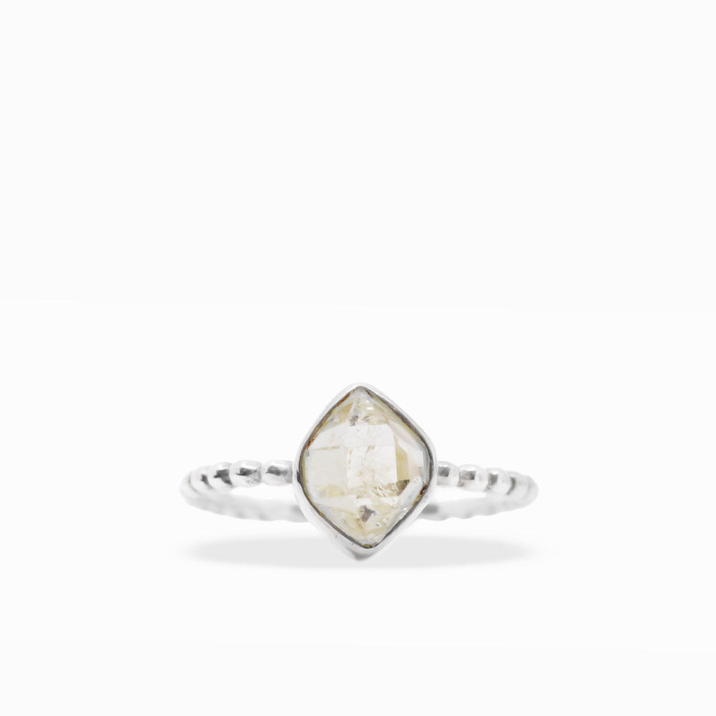 Clear diamond-shaped Herkimer Diamond Quartz ring with natural inclusions, sterling silver bezel setting, and textured beaded band.