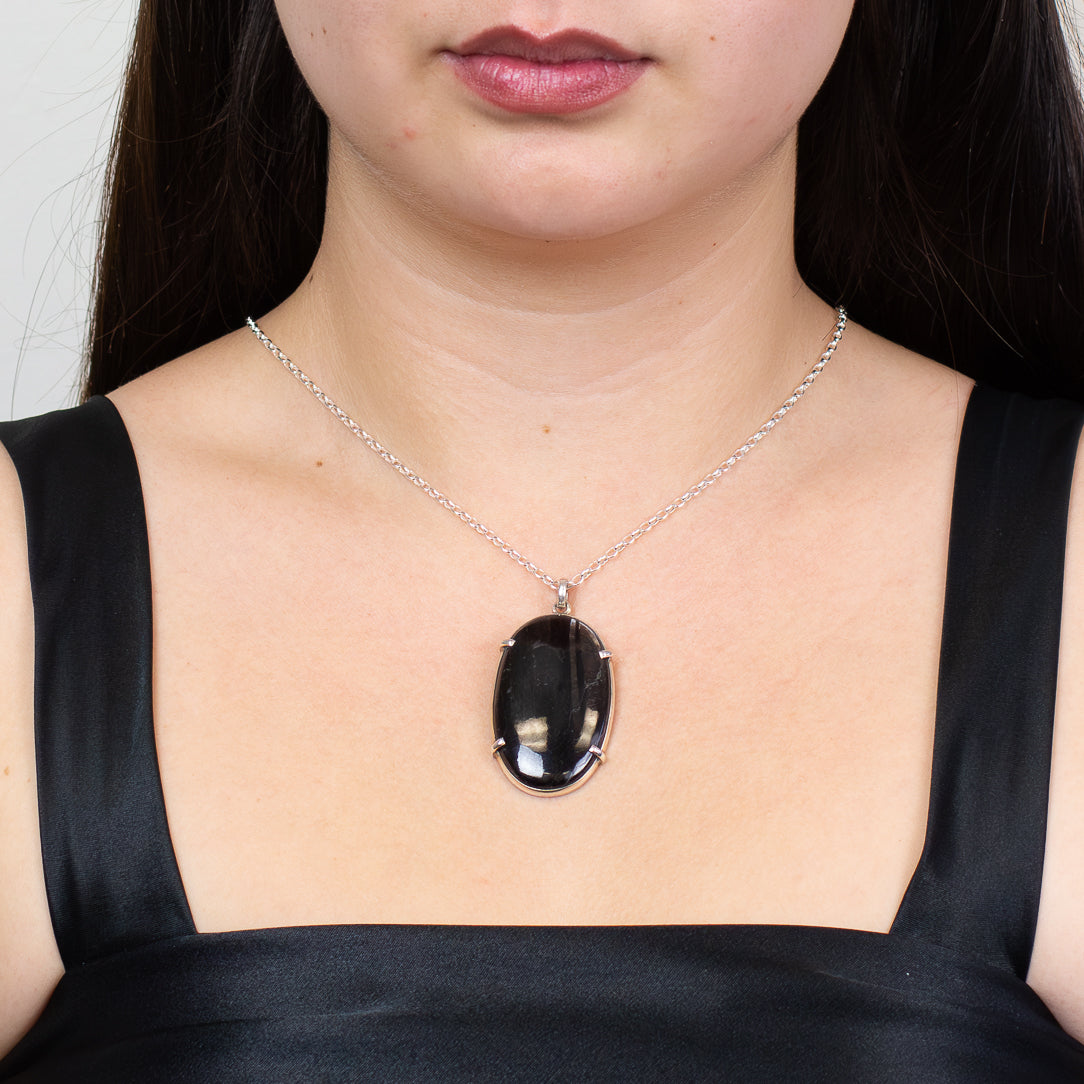 Oval hypersthene cabochon pendant set in sterling silver on chain. MADE IN EARTH