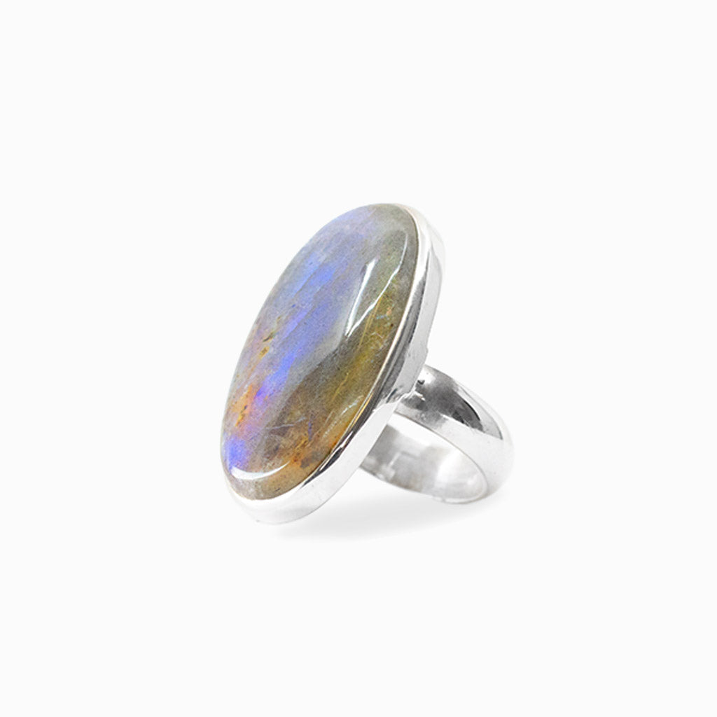 Elongated oval Labradorite cabochon with vivid blue flash set in polished 925 sterling silver.