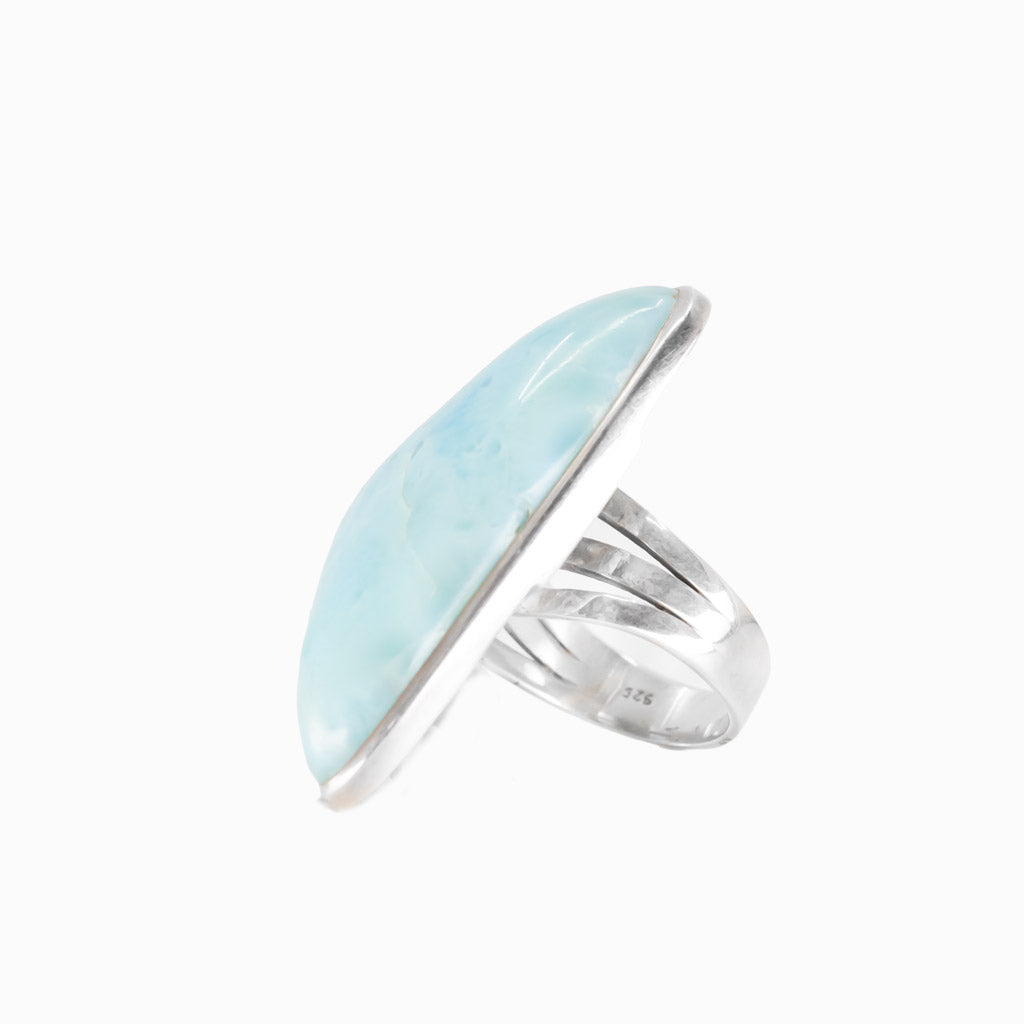 Larimar triangle cabochon ring in sterling silver bezel. Ocean-blue gemstone with natural marbling in a modern, sculptural design.
