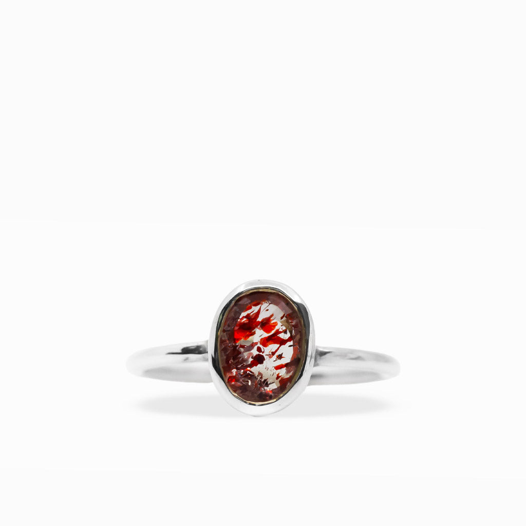 Oval Lepidocrocite in Quartz ring with vivid red mineral inclusions suspended in translucent crystal and polished sterling silver bezel.