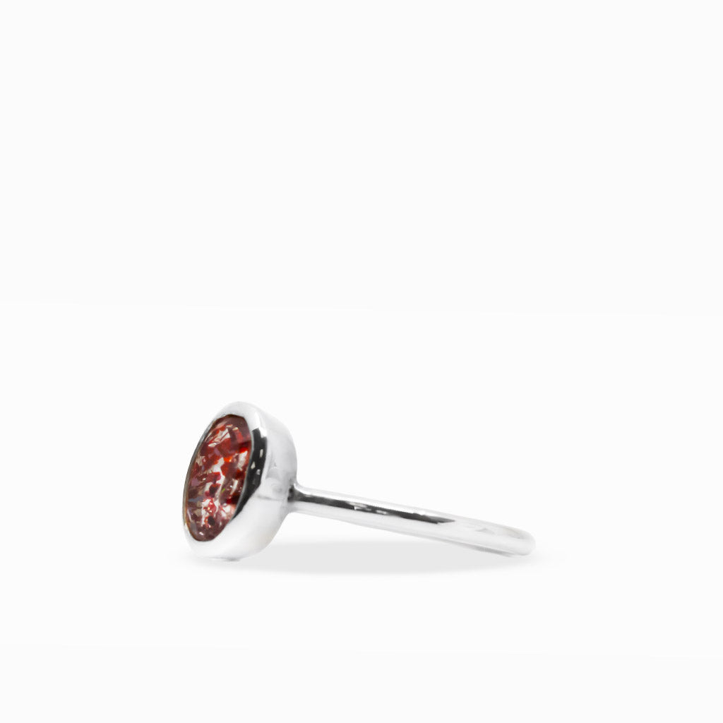 Oval Lepidocrocite in Quartz ring with vivid red mineral inclusions suspended in translucent crystal and polished sterling silver bezel.