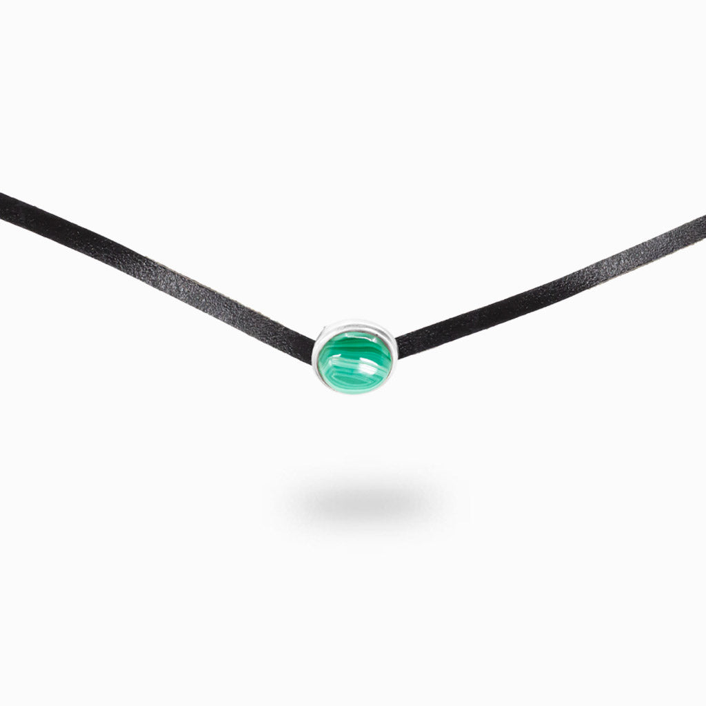 Malachite leather necklace featuring a polished green banded gemstone set in sterling silver on black cord.