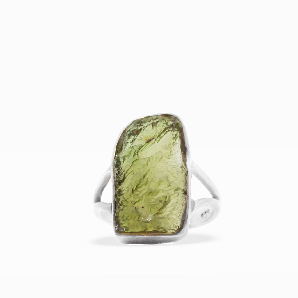 Translucent olive-green freeform Moldavite ring with textured natural surface, sterling silver bezel setting, and split band.