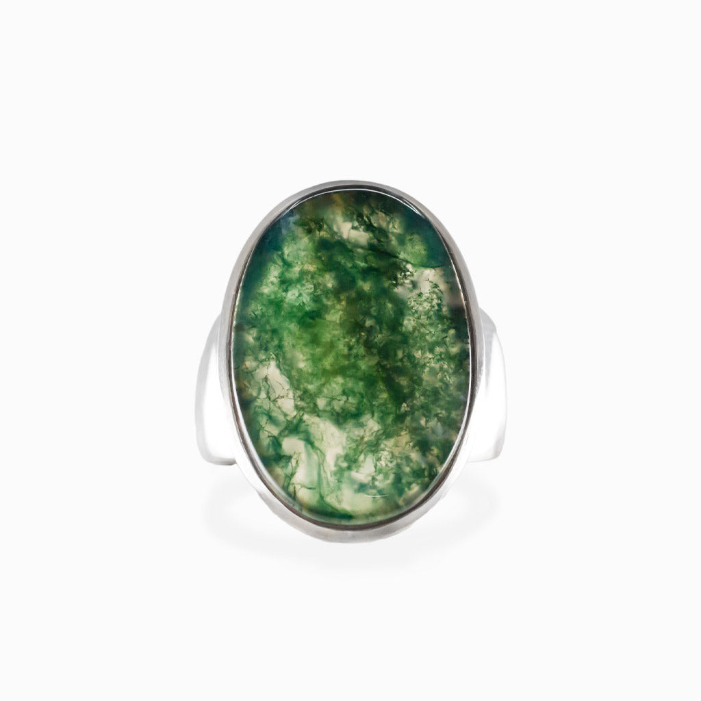 Oval Moss Agate cabochon sterling silver statement ring with natural green moss-like inclusions.