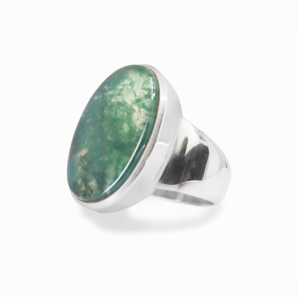 Oval Moss Agate cabochon sterling silver statement ring with natural green moss-like inclusions.