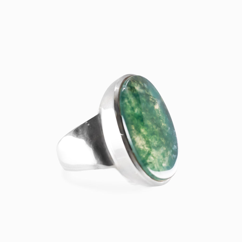 Oval Moss Agate cabochon sterling silver statement ring with natural green moss-like inclusions.