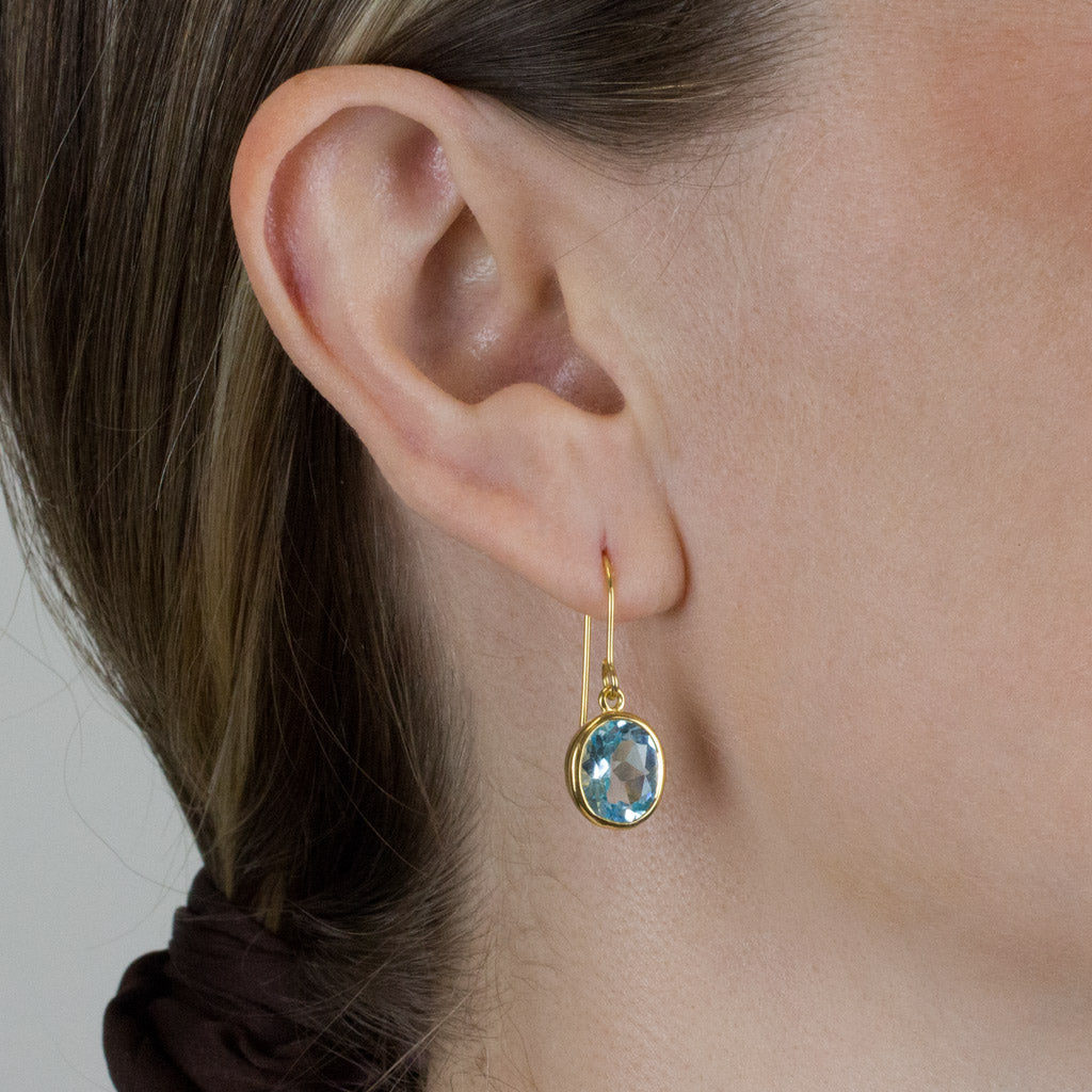 Blue Topaz drop earrings with gold vermeil finish on Model