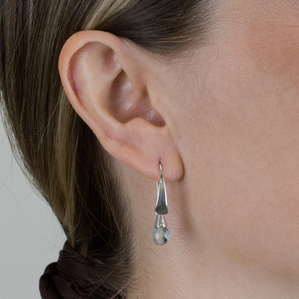 Blue topaz drop earrings on model