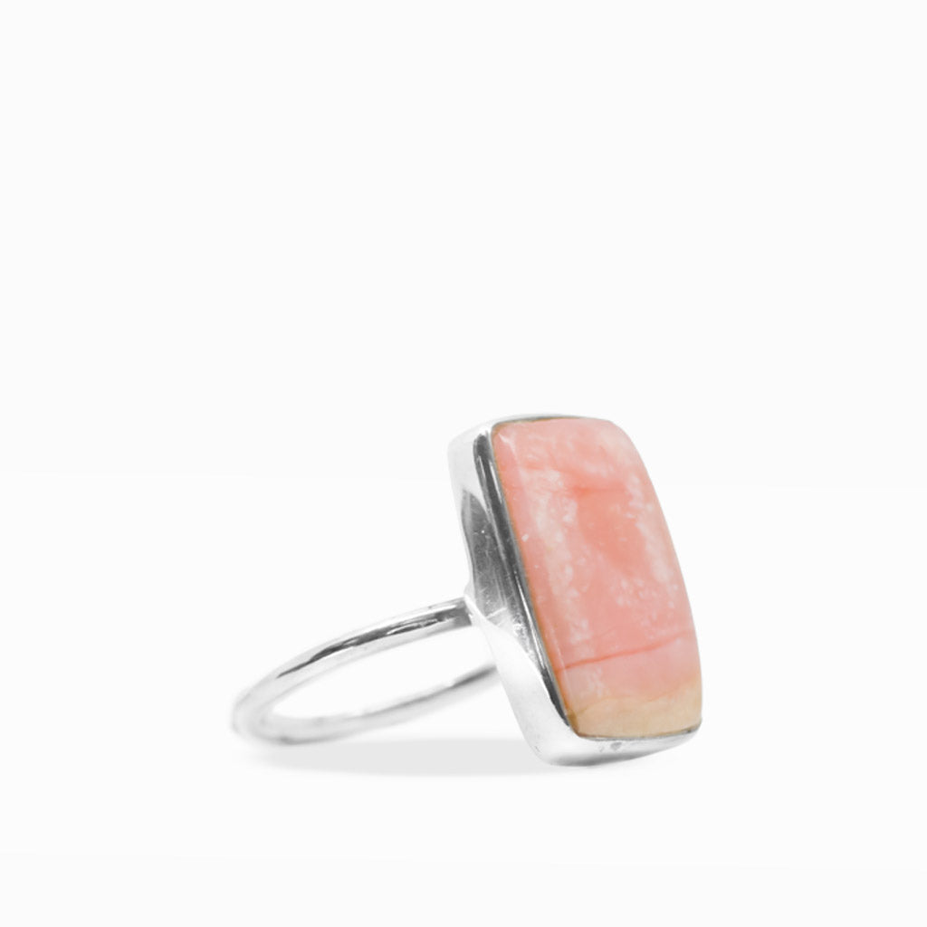 Rectangular peach-pink Opal cabochon ring with soft cream and golden tones, polished sterling silver bezel, and slim band.