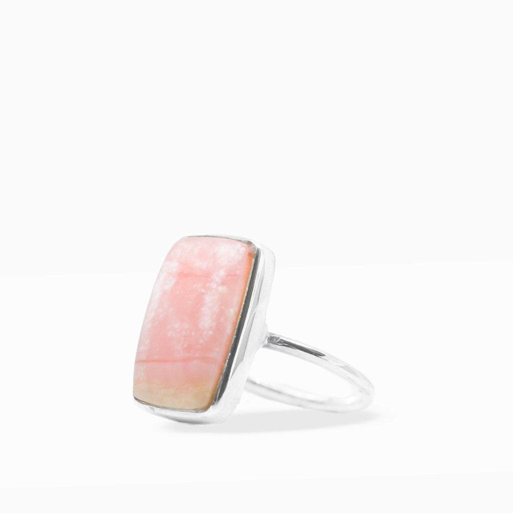 Rectangular peach-pink Opal cabochon ring with soft cream and golden tones, polished sterling silver bezel, and slim band.
