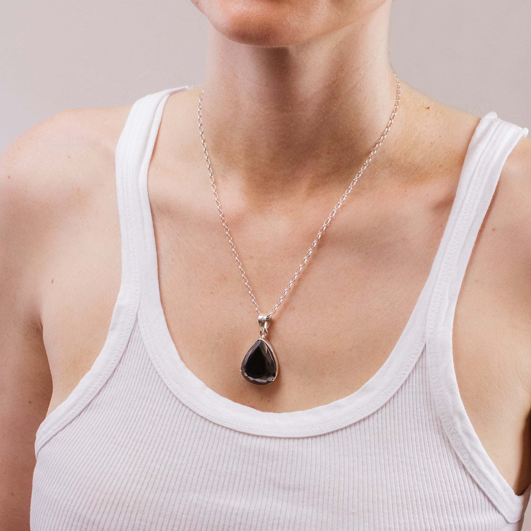 FACETED TEAR HEMATITE NECKLACE ON MODEL
