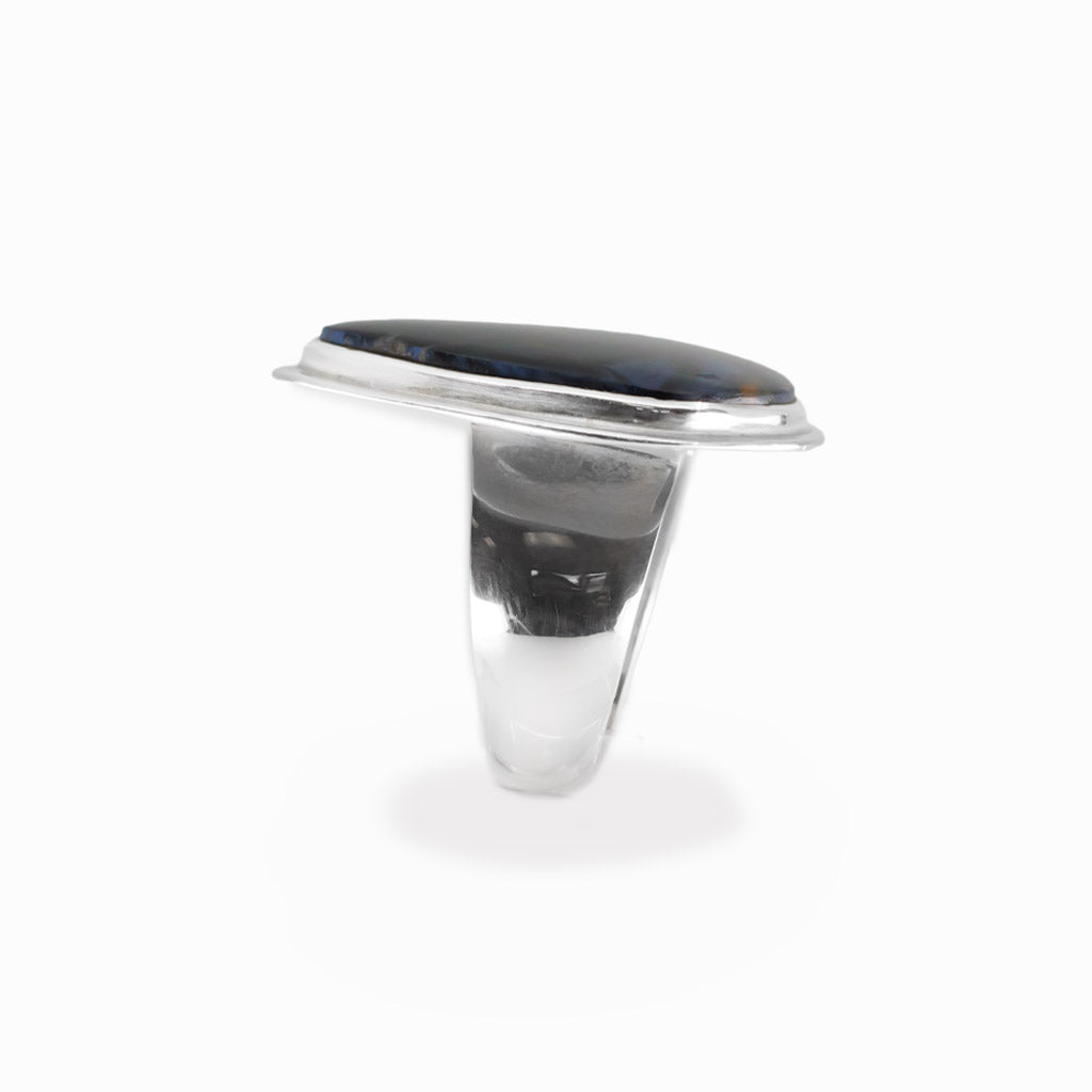 Pietersite triangular cabochon ring in polished sterling silver with swirling navy blue, electric blue and golden-brown natural patterns.