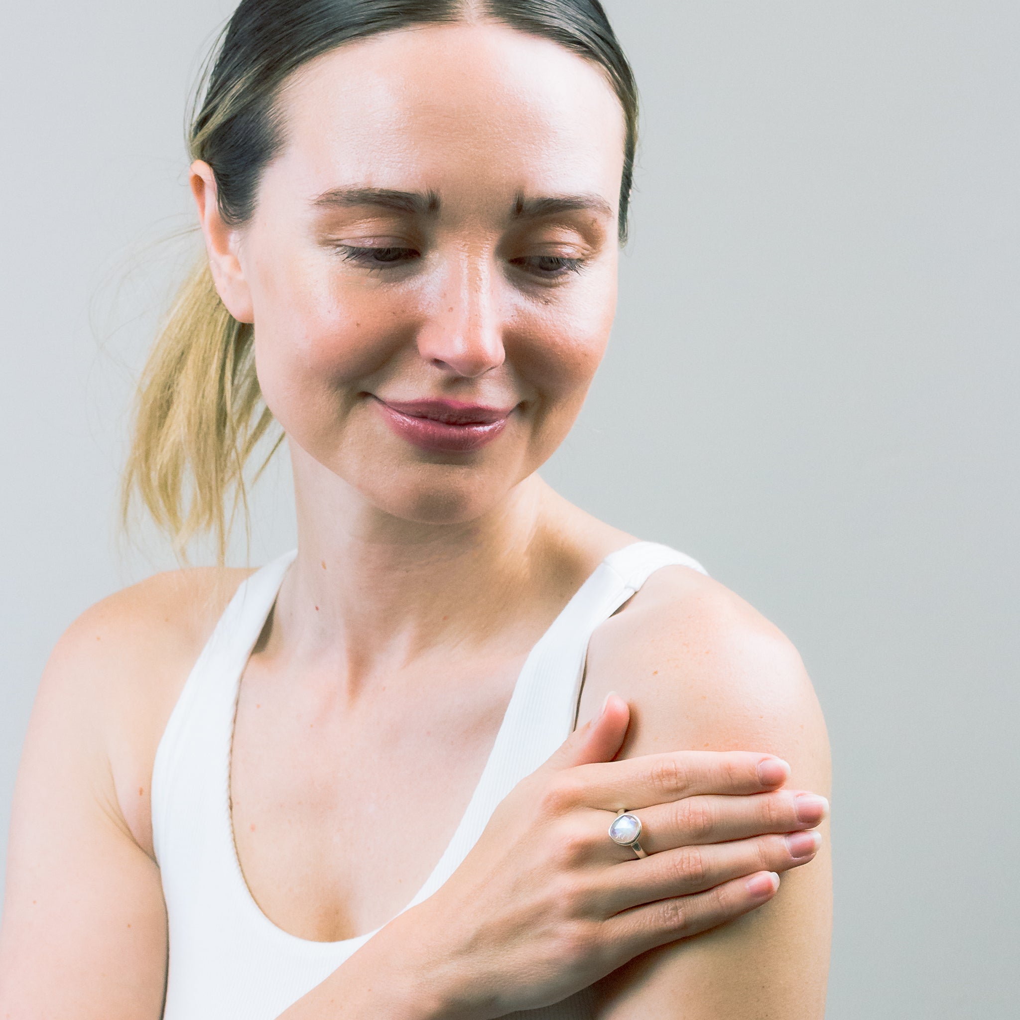 FACETED OVAL RAINBOW MOONSTONE RING ON MODEL