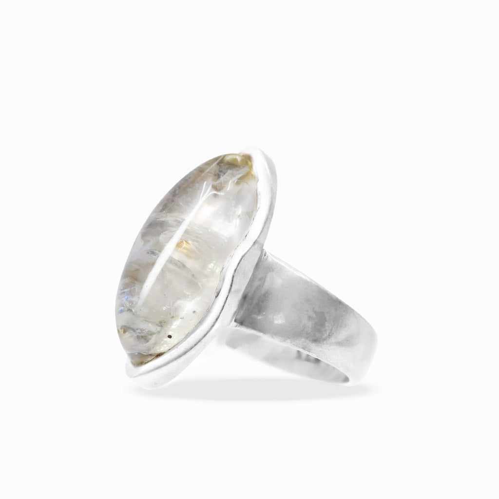 Marquise-shaped Rainbow Moonstone ring with translucent white gemstone, subtle blue flash, and polished sterling silver bezel setting.