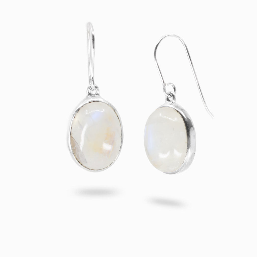 Sterling silver rainbow moonstone earrings featuring oval cabochon gemstones with soft blue iridescence.