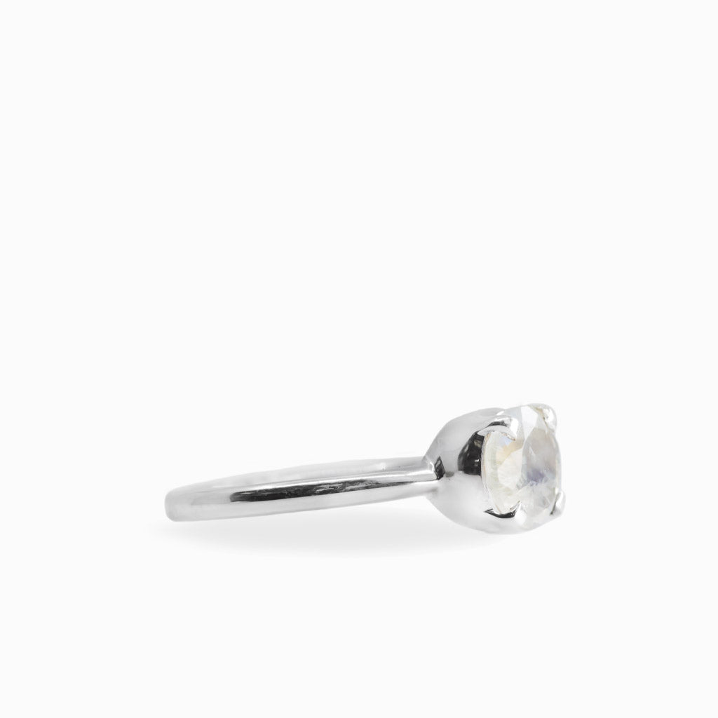 Round faceted Rainbow Moonstone ring in polished 925 sterling silver with blue flashes, four-prong setting and slender band.