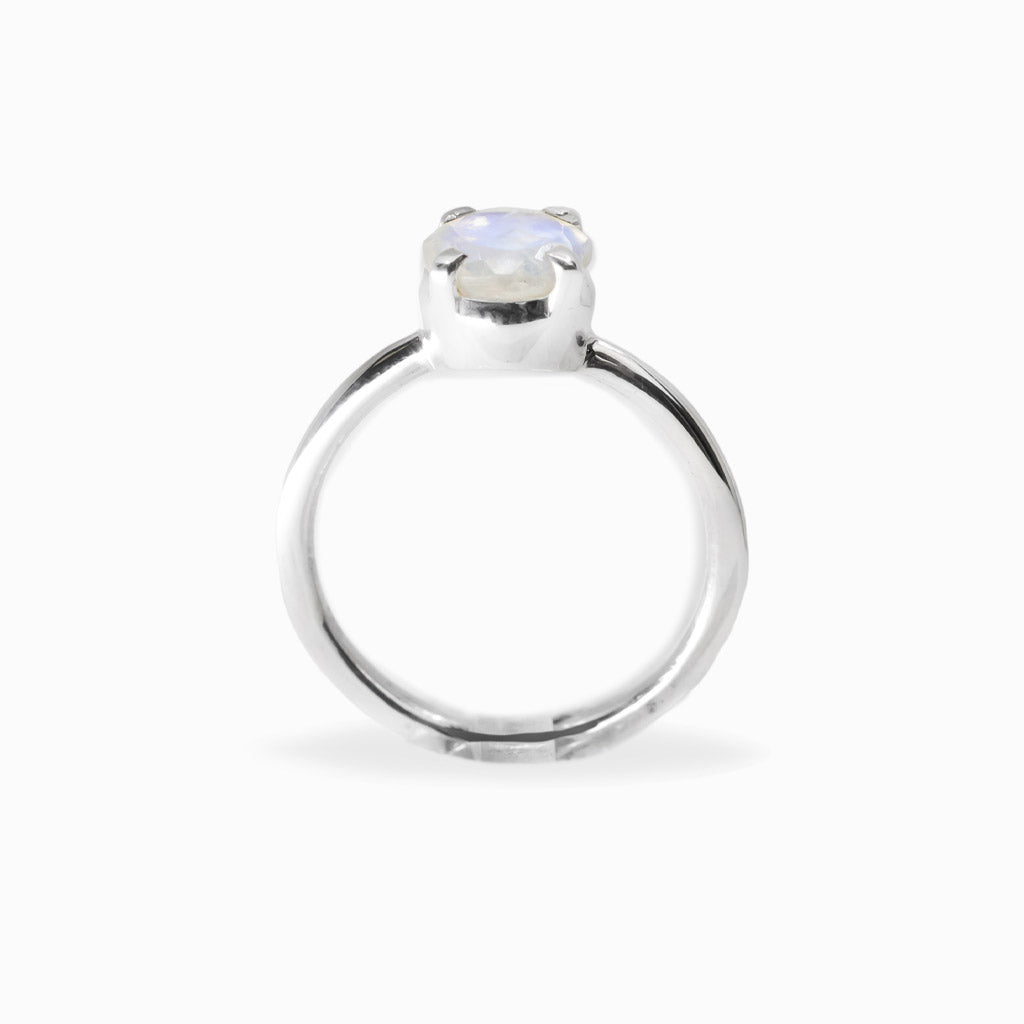 Round faceted Rainbow Moonstone ring in polished 925 sterling silver with blue flashes, four-prong setting and slender band.