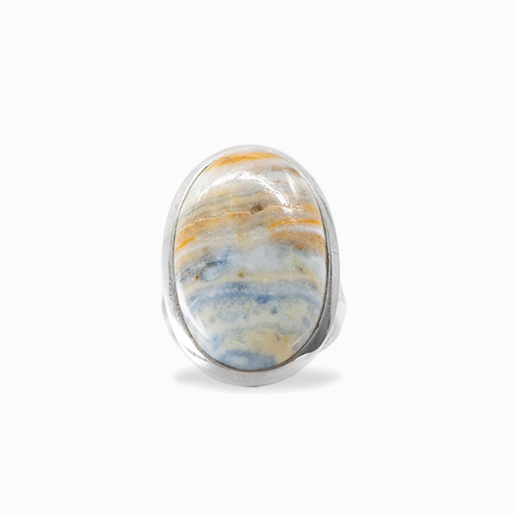Oval Scheelite cabochon with natural cream, blue and golden banding set in 925 sterling silver.