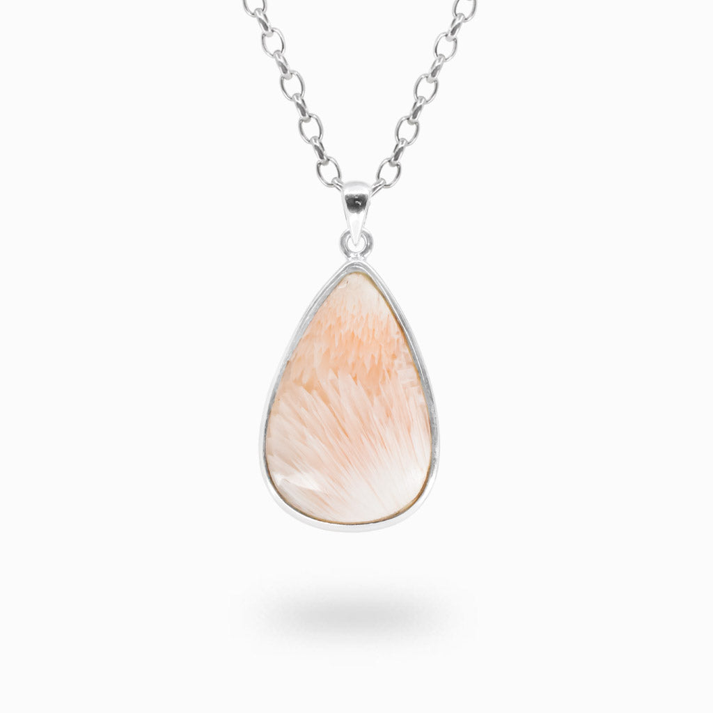 Pear-shaped Pink Scolecite pendant with peach-pink and white radiating feathery patterns in polished 925 sterling silver.