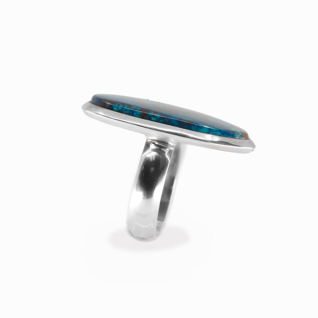 Shattuckite elongated oval cabochon ring in polished sterling silver with vivid turquoise blue and earthy copper-brown mineral patterns.