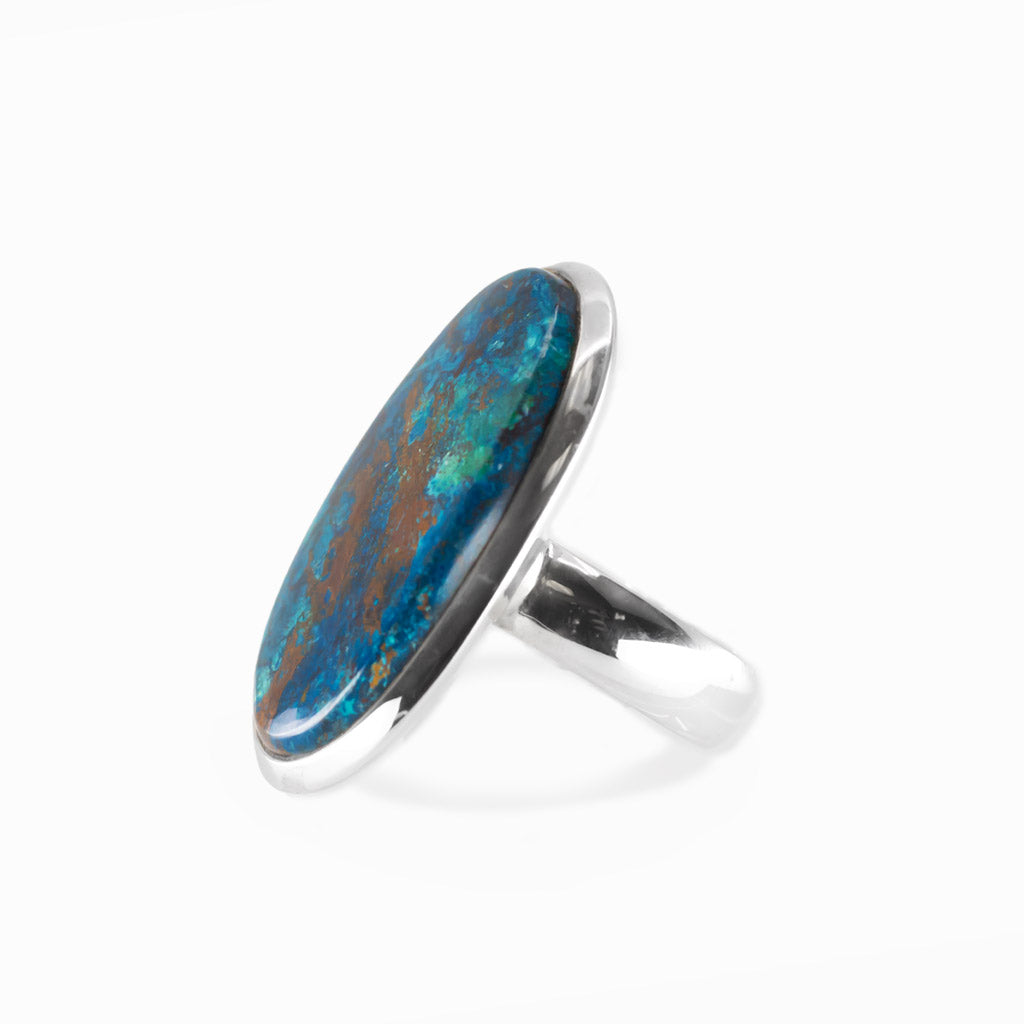 Shattuckite elongated oval cabochon ring in polished sterling silver with vivid turquoise blue and earthy copper-brown mineral patterns.