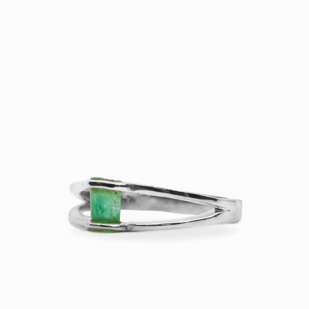 Raw rectangular green Emerald ring in polished 925 sterling silver with an open horizontal silver setting.