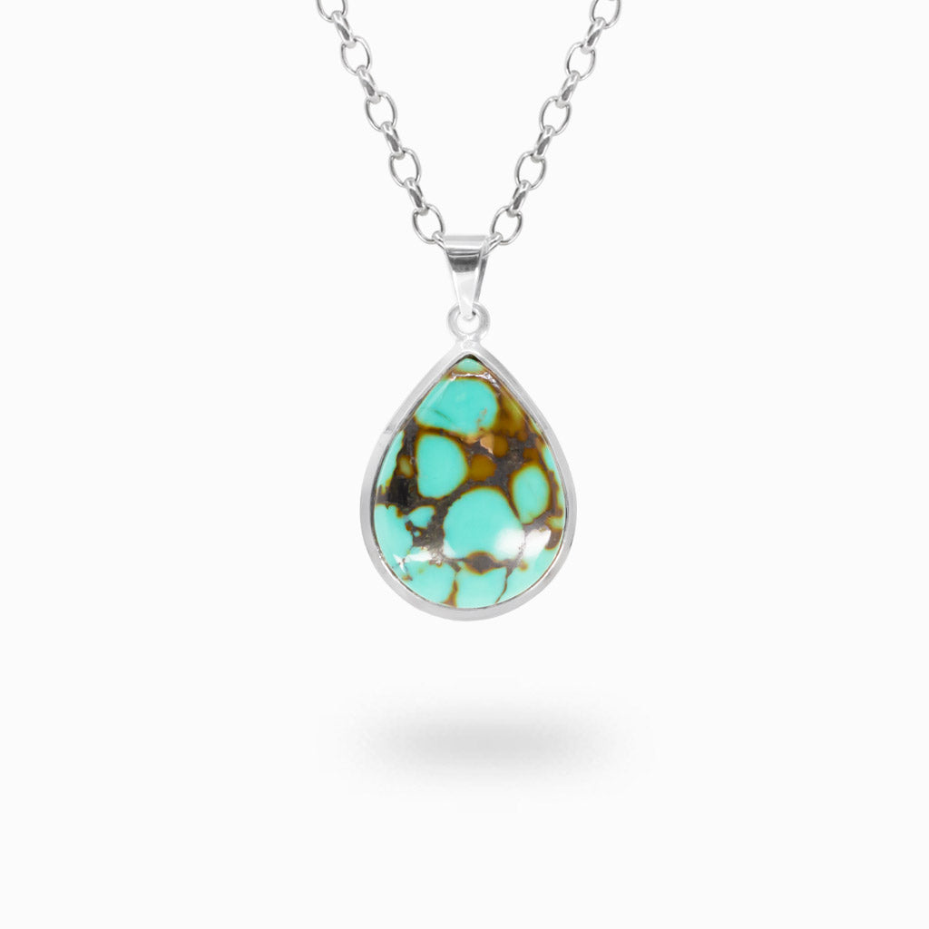 Pear-shaped aqua-blue Tibetan Turquoise cabochon pendant with bold brown and dark matrix patterns in polished 925 sterling silver.
