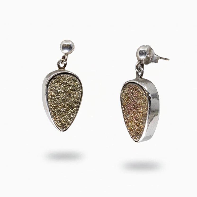 A pair of silver stud earrings featuring teardrop-shaped druzy pendants with a textured, glittery gold and bronze finish, shown against a plain white background.