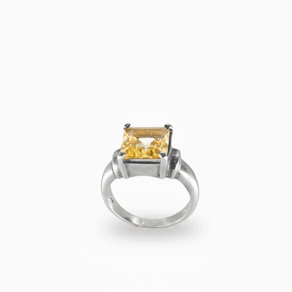 Rectangular faceted Citrine ring in polished 925 sterling silver with a warm golden-yellow gemstone and prong setting.