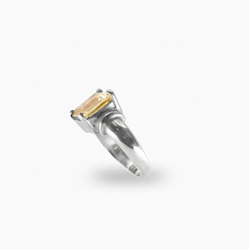 Rectangular faceted Citrine ring in polished 925 sterling silver with a warm golden-yellow gemstone and prong setting.