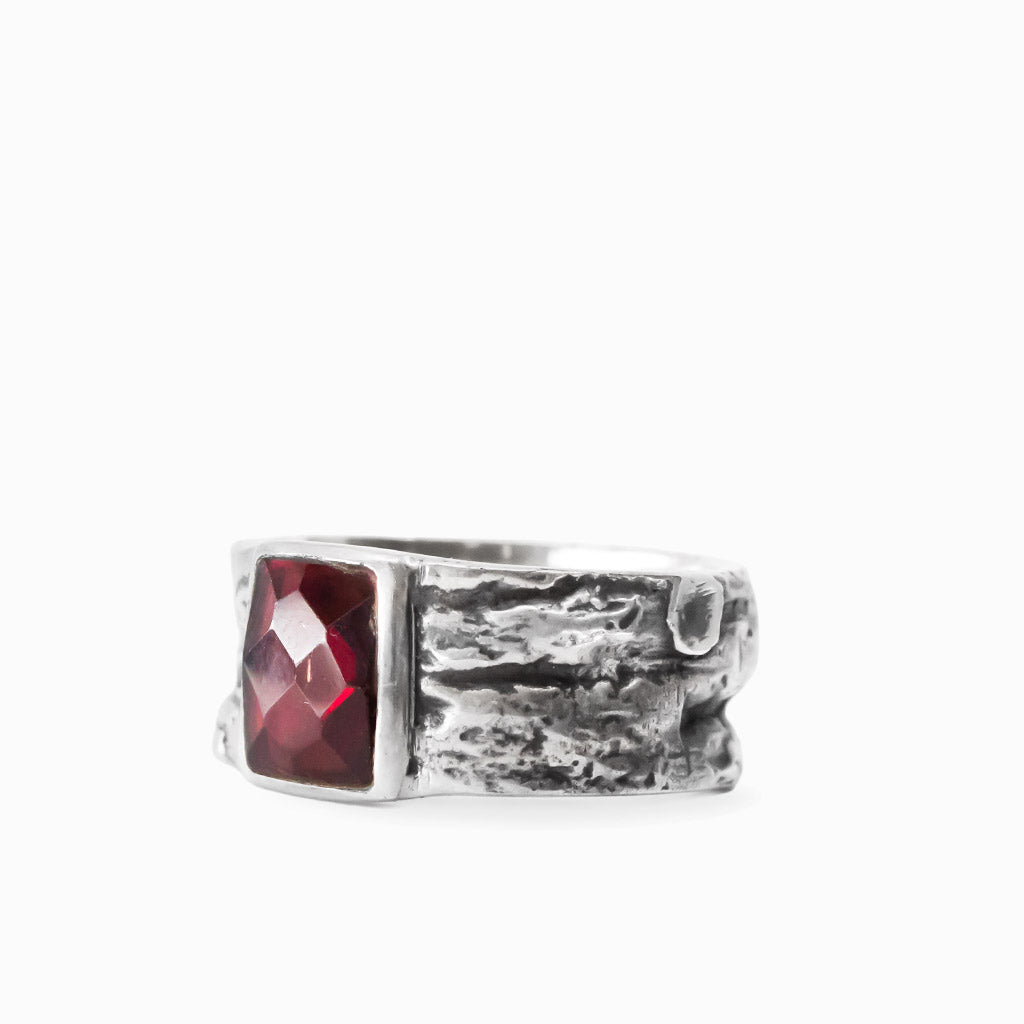 Rectangular faceted red Garnet gemstone set in a wide textured 925 sterling silver ring.