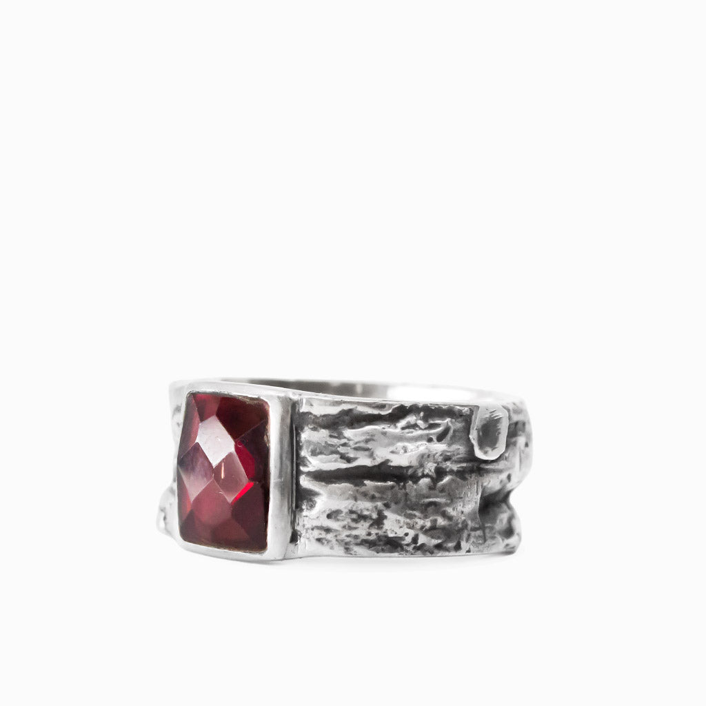 Rectangular faceted red Garnet gemstone set in a wide textured 925 sterling silver ring.