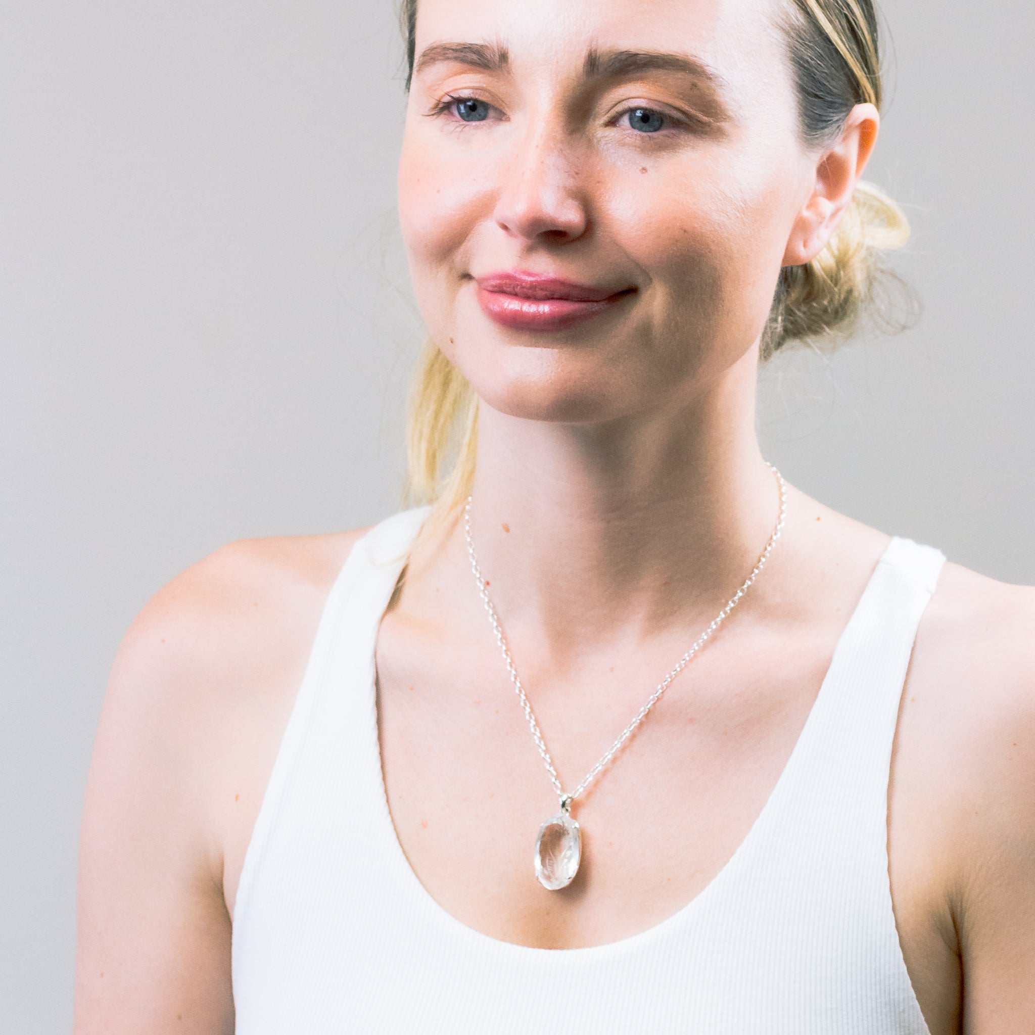 CARVED CLEAR QUARTZ NECKLACE ON MODEL