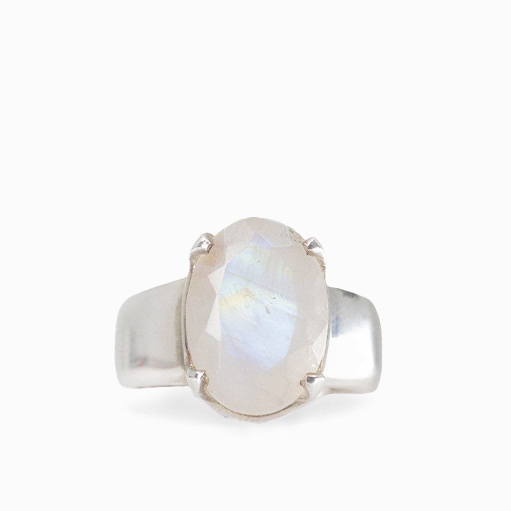 A sterling silver ring featuring an oval-cut iridescent moonstone gemstone, set in a simple prong setting on a clean white background.