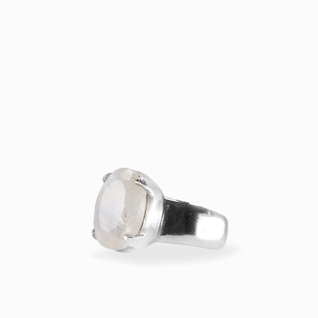 A silver ring featuring a large, oval-shaped milky white gemstone in a prong setting, shown against a plain white background.